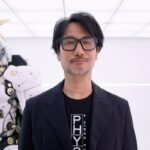 PHYSINT: Hideo Kojima neben einer Ludens-Figur