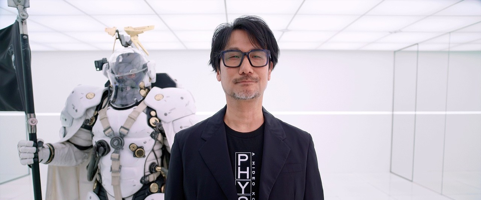 PHYSINT: Hideo Kojima neben einer Ludens-Figur