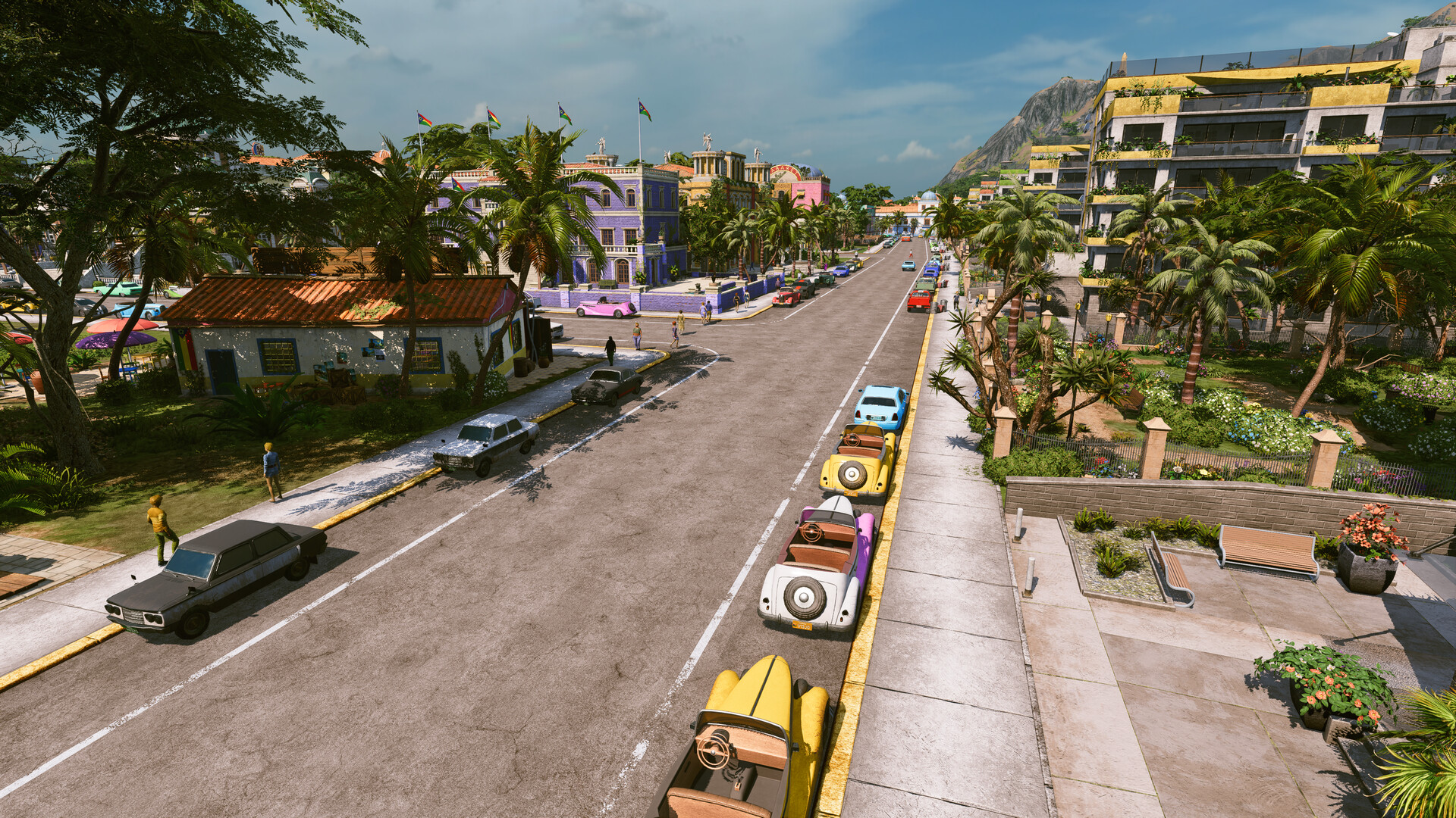 Kalypso Media veröffentlicht Tropico 7: Screenshot einer Straße mit Oldtimern und Palmen