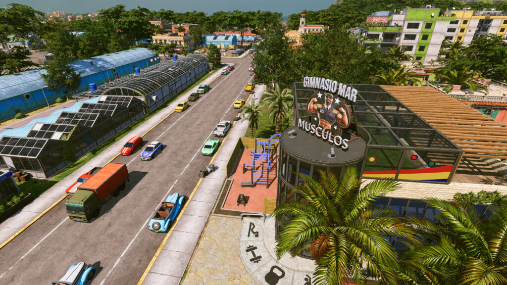 Tropico 7 Screenshot: Straße mit Gewächshäusern, Lastwagen und einem Fitnessstudio