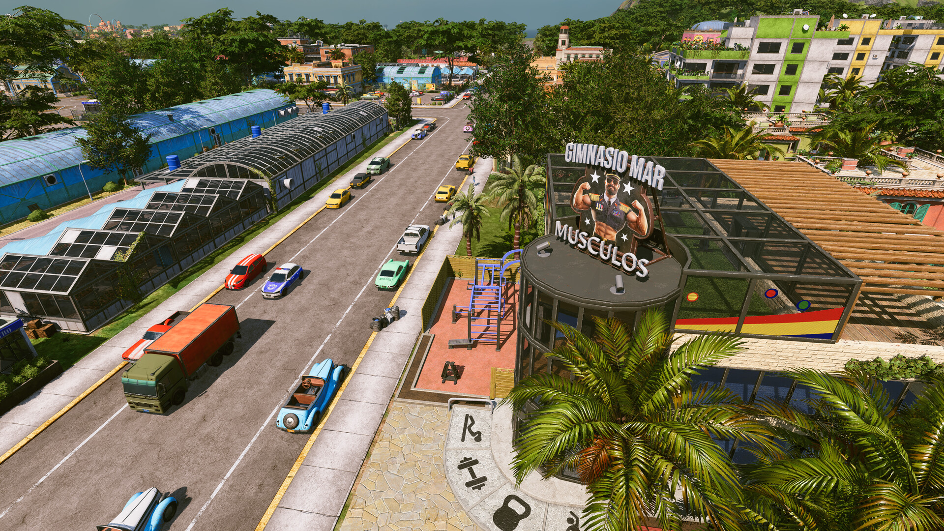 Tropico 7 Screenshot: Straße mit Gewächshäusern und Fitnessstudio